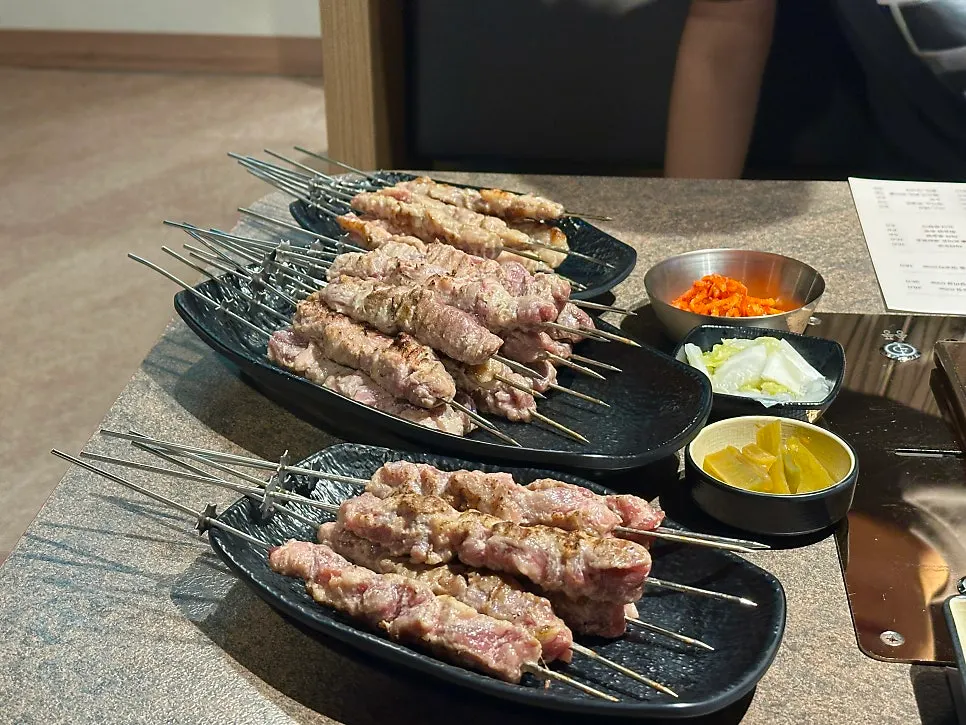 Pre-grilled lamb skewers set out with basic side dishes
