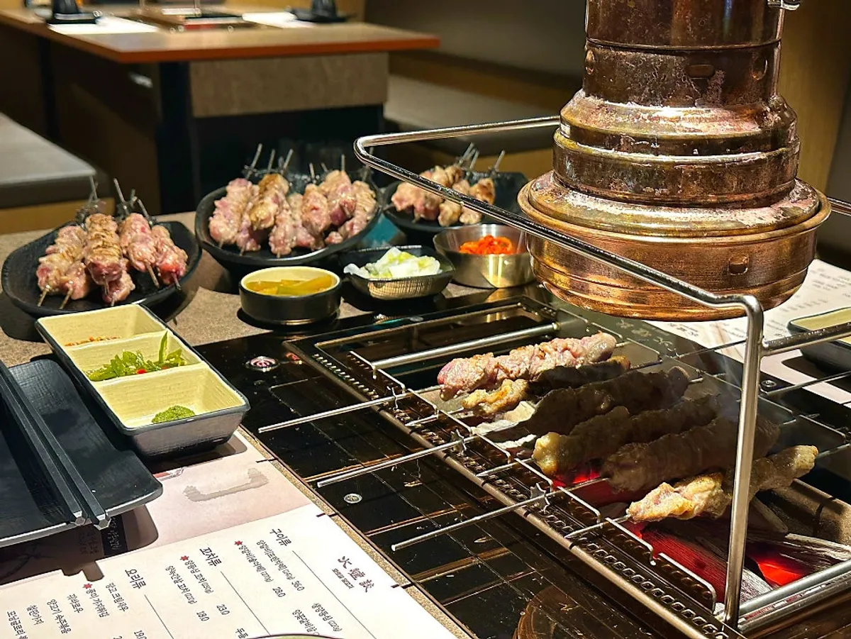 Lamb skewers rotating automatically over the charcoal