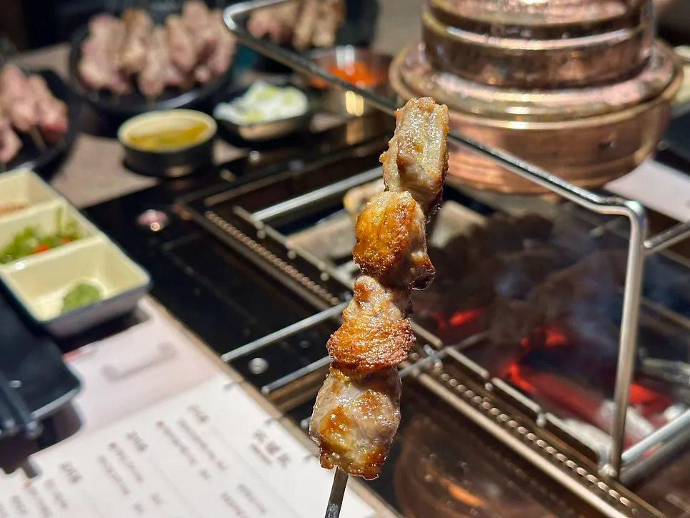 Close-up of thick lamb skewers grilling