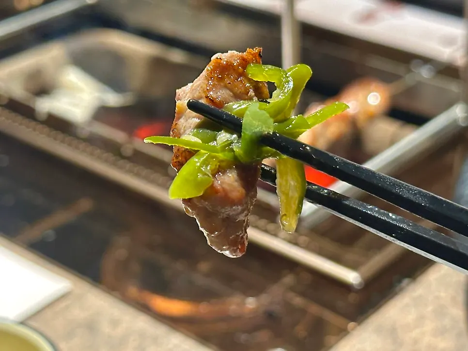 A piece of lamb skewer paired with pickled peppers