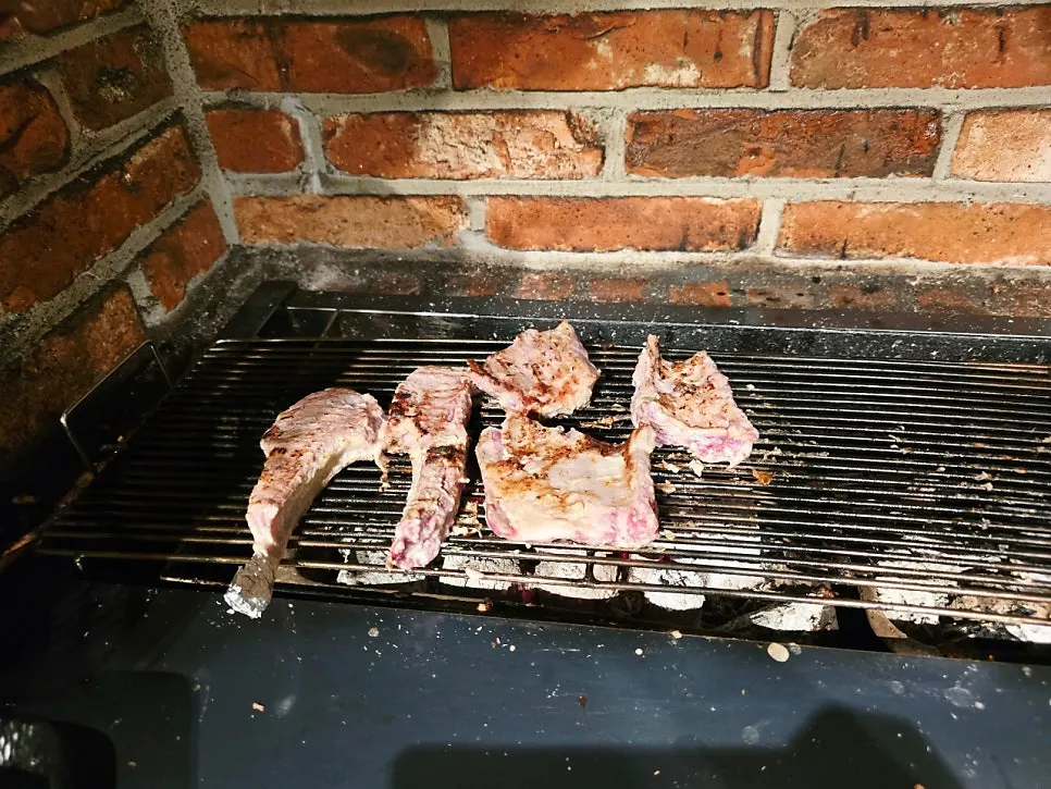 Lamb being pre-grilled over the fire pit