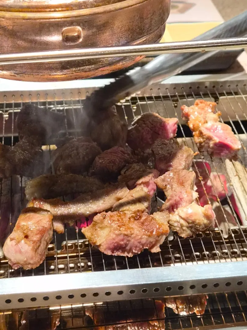 Shoulder rack lamb chops grilling over charcoal