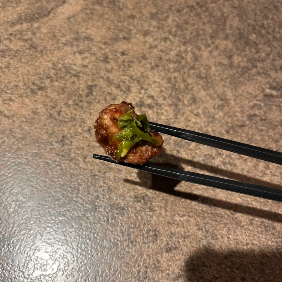 Thick lamb sirloin skewer over charcoal