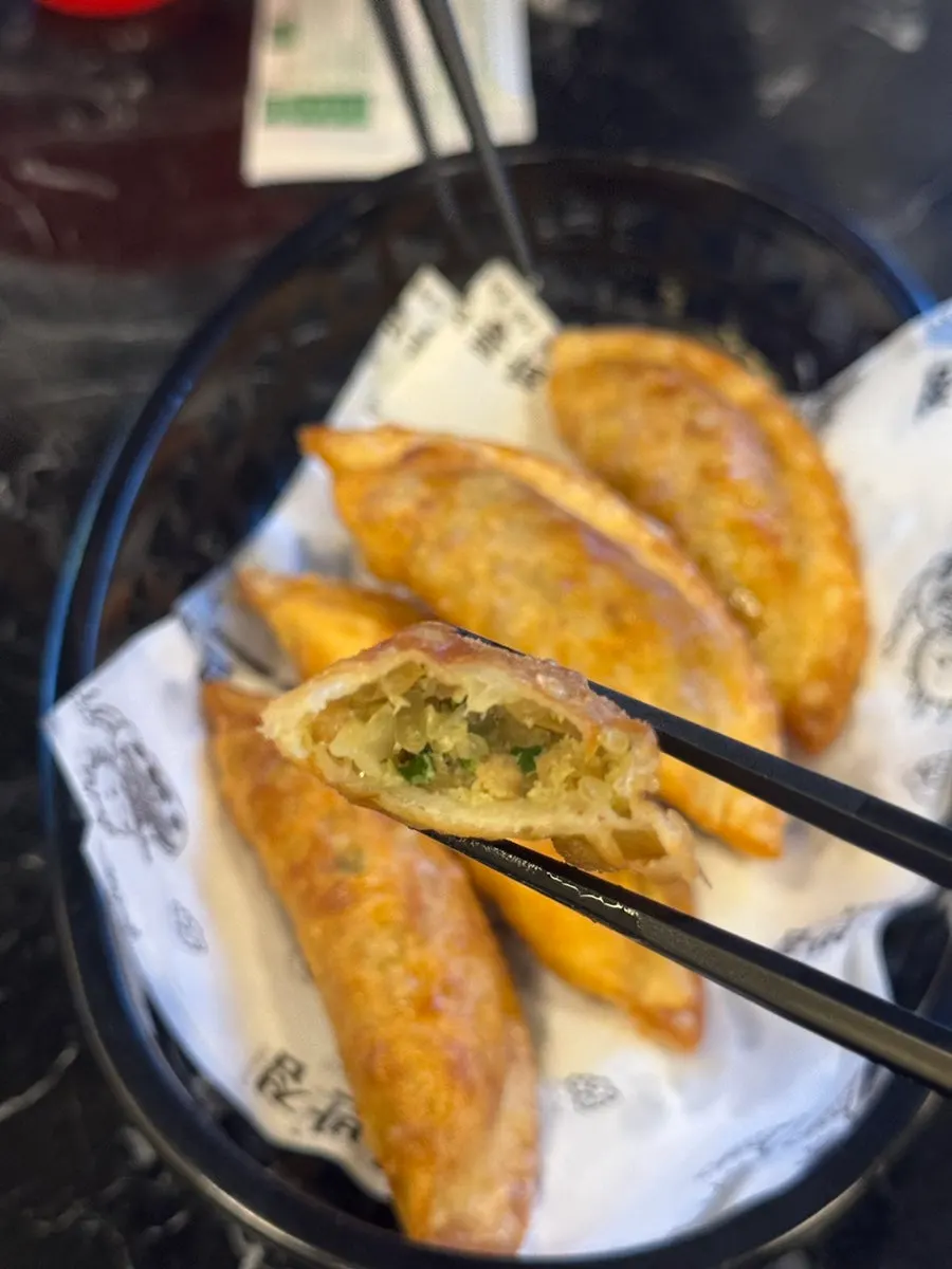 Beer glass with a plate of fried dumplings