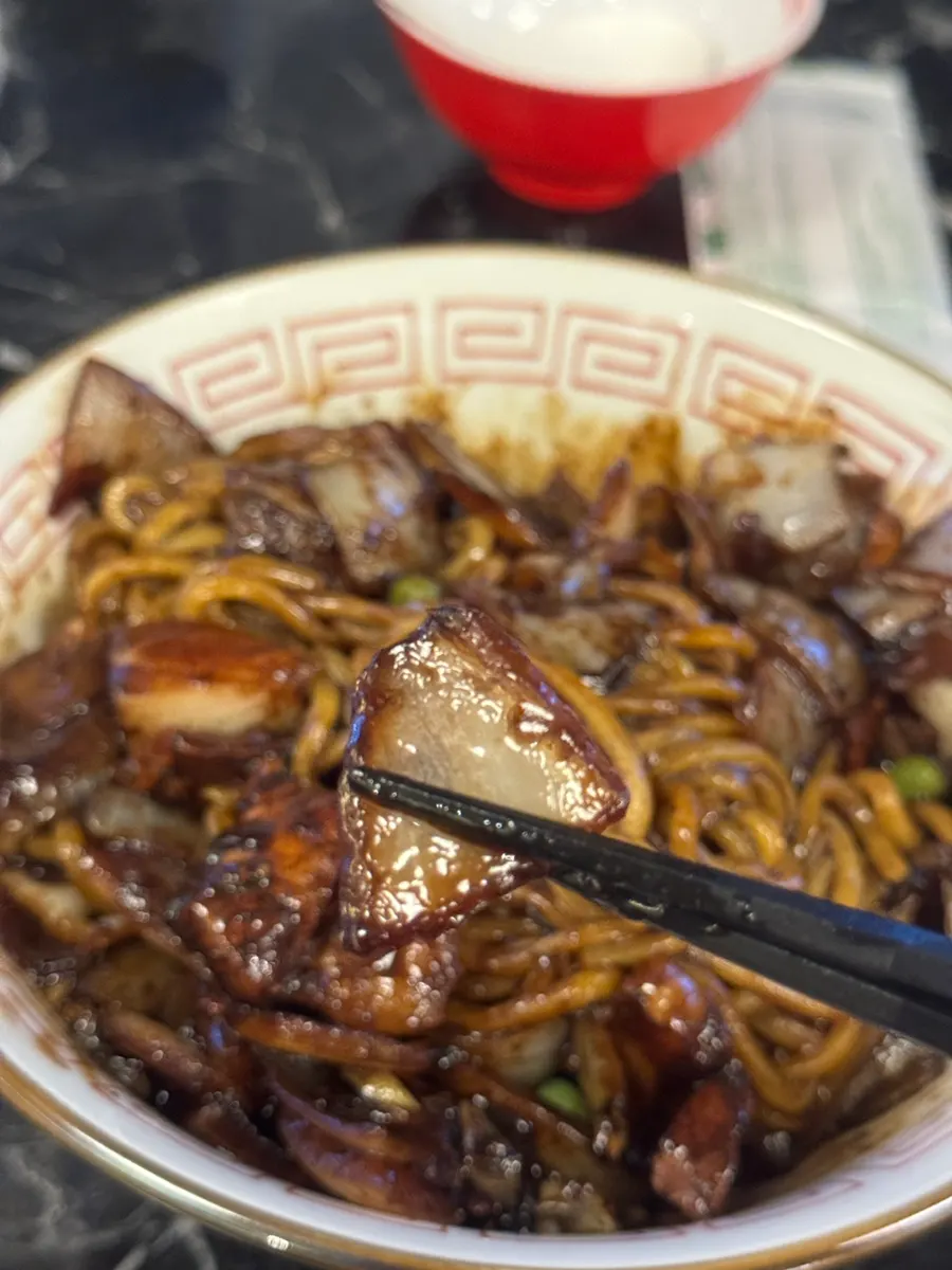 Picking up a piece of sweet and sour pork