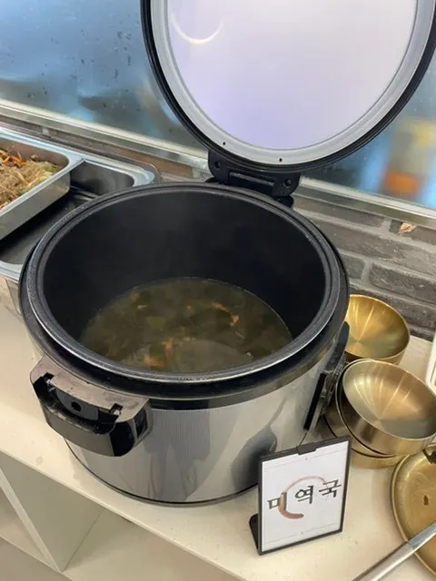 Hwadamga self-serve bar with assorted side dishes