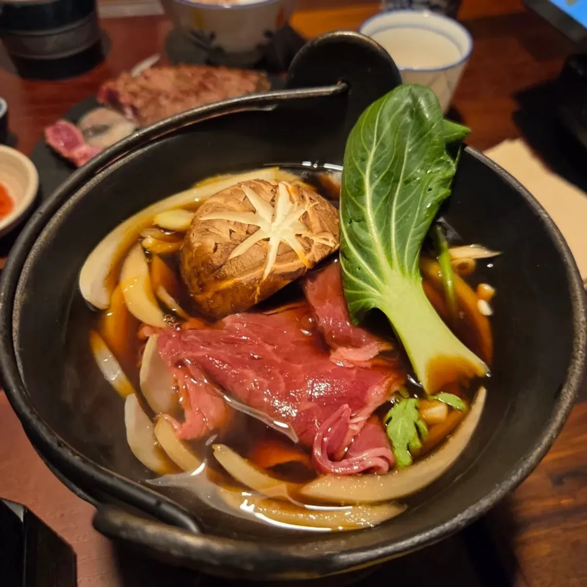 Sukiyaki set with meat, vegetables, and raw egg