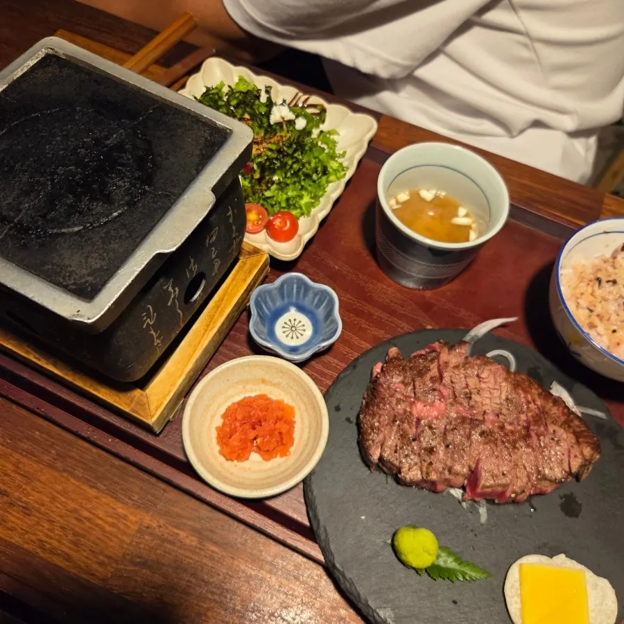 Meat and udon noodles simmering in sukiyaki broth
