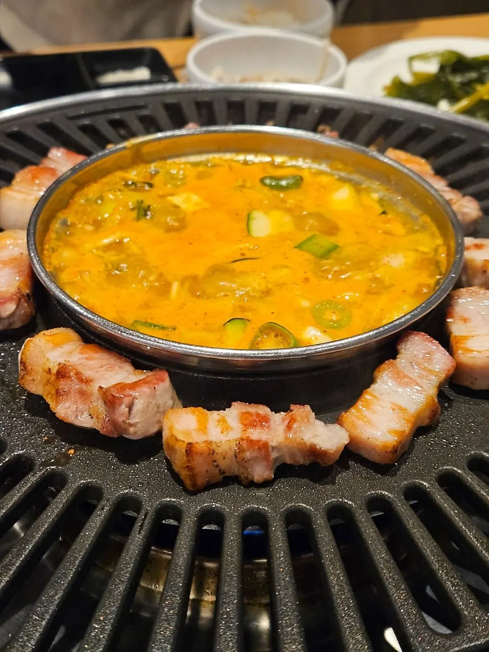 Doenjang jjigae bubbling in the center of the table