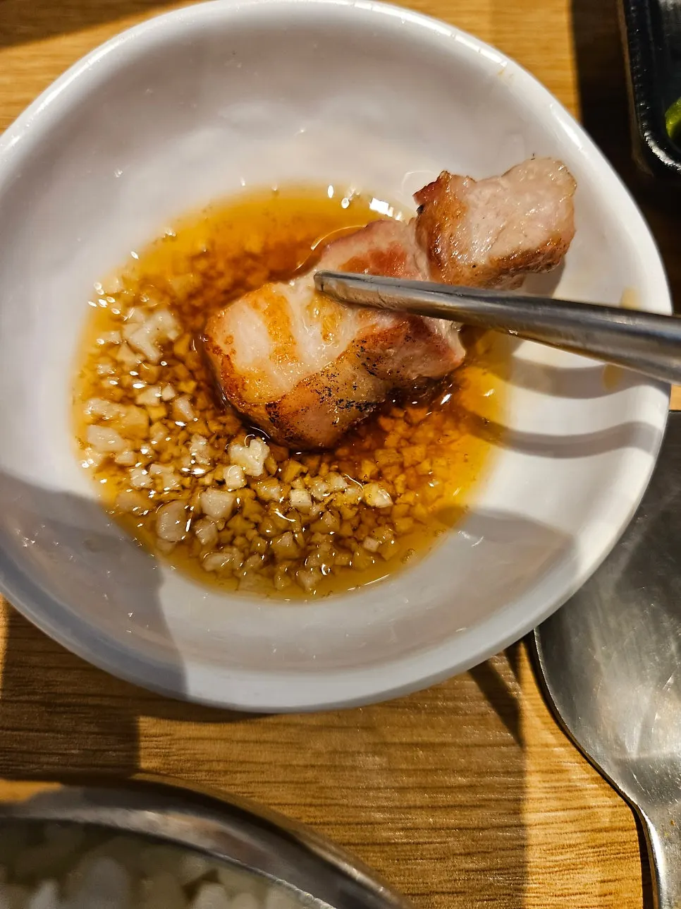 A piece of pork belly topped with wasabi