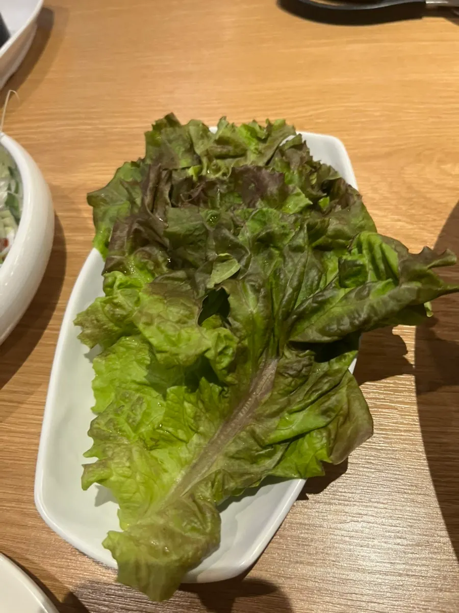 Self-bar side dishes including chive kimchi and wild garlic leaves