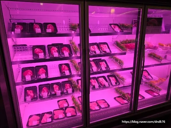 Fridge display of vacuum-packed meat by cut