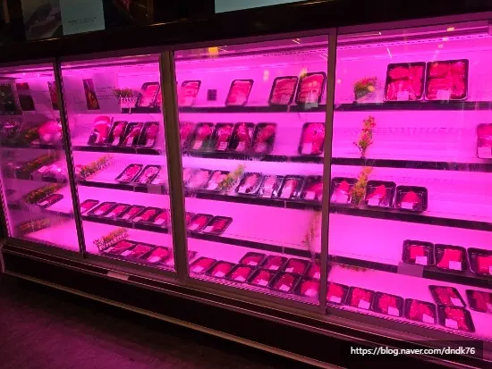 Display case of packaged beef and pork