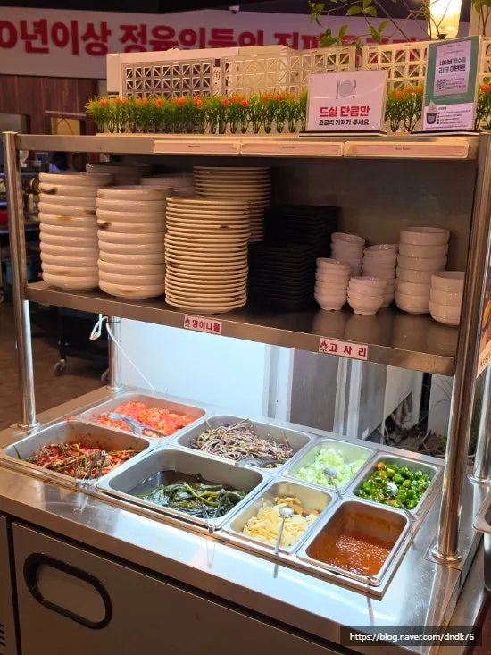 Self-serve side dish station with green onion kimchi and myeongi namul