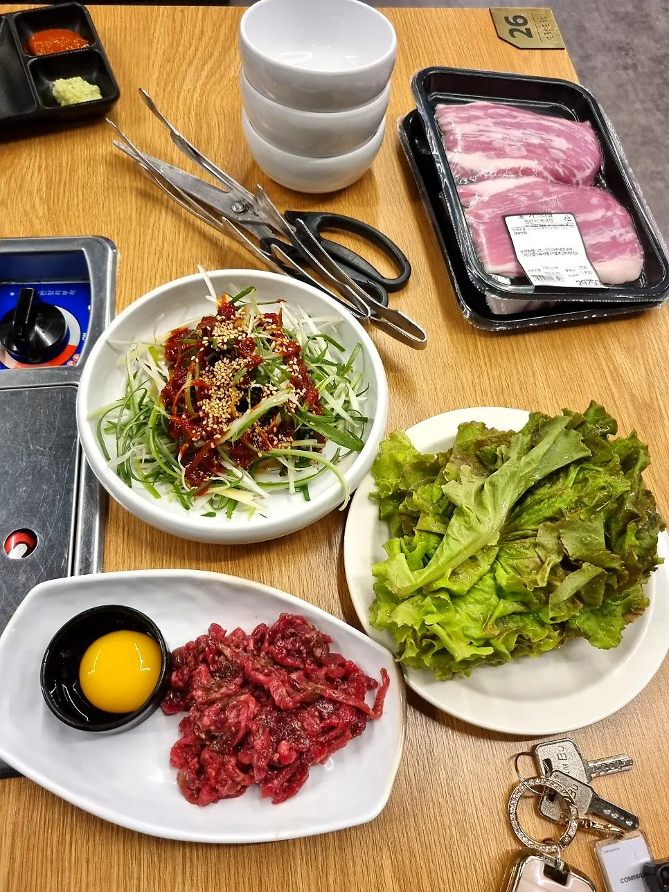 Basic table setting with beef tartare and side dishes