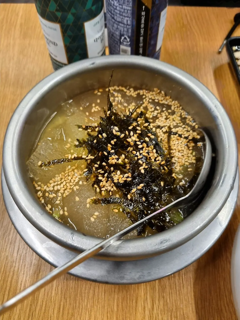 Table setting with acorn jelly soup and shredded scallion salad