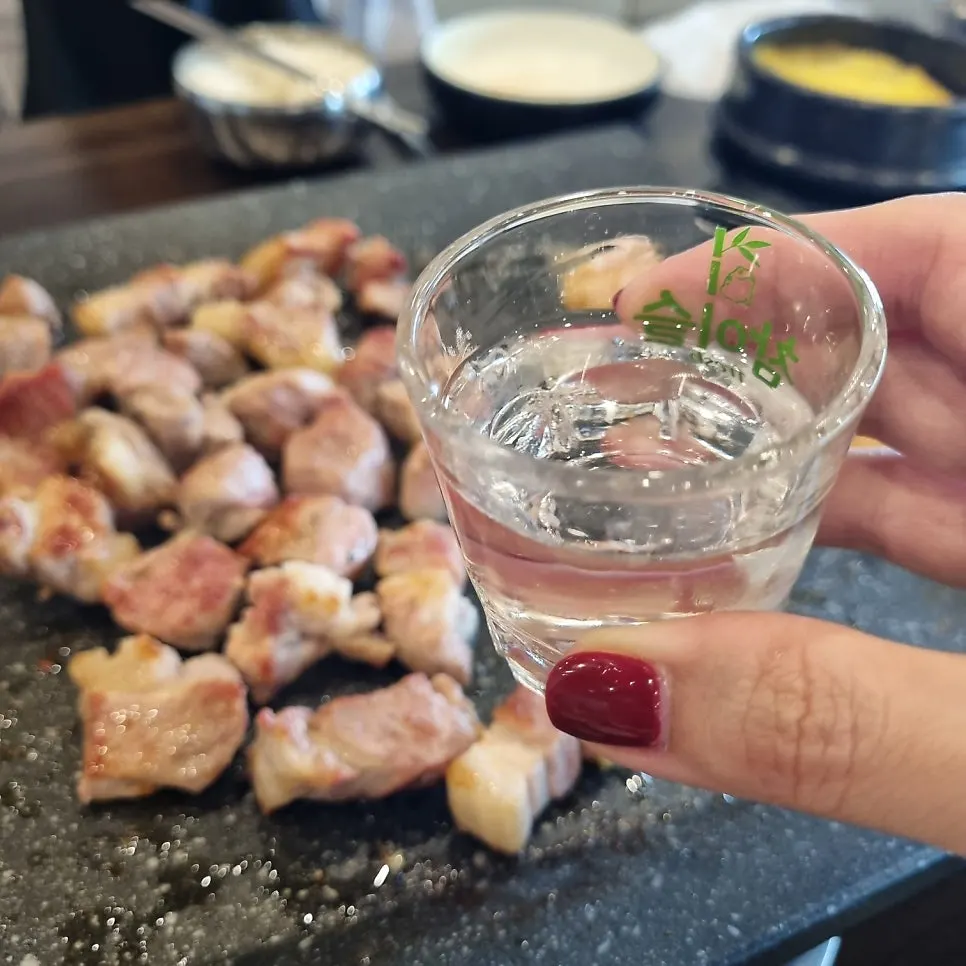 A wrap of radish with meat and shredded green onion on top