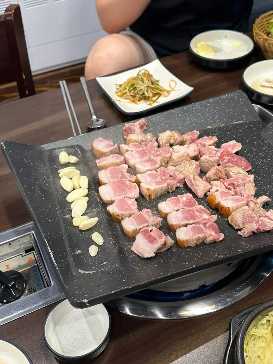 Oak-fired pork placed on the tabletop grill