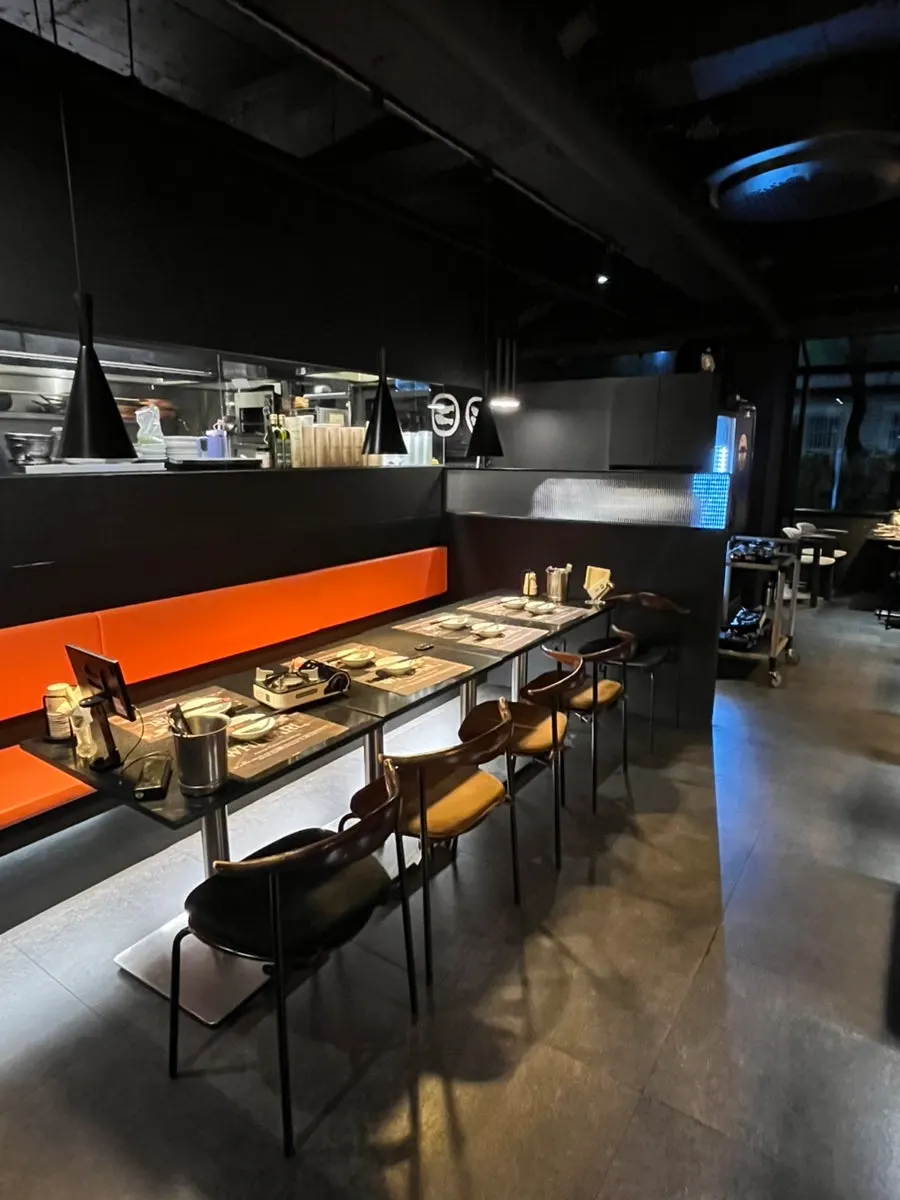 Dimly lit table seating inside Hwieol Migeum Branch
