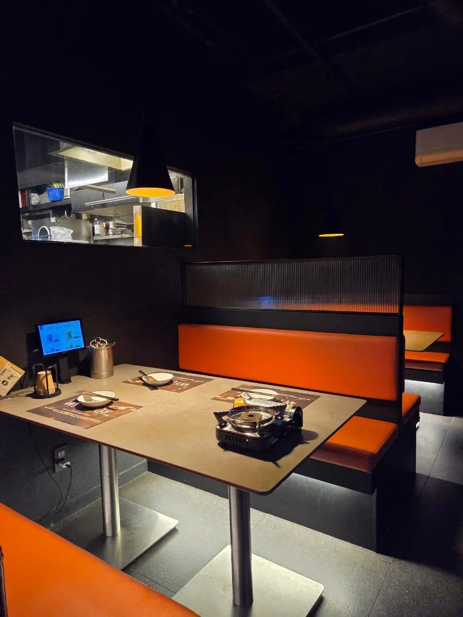 Seating with orange chairs and tables