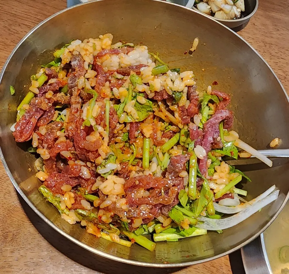Bibimbap topped with Korean beef yukhoe and vegetables