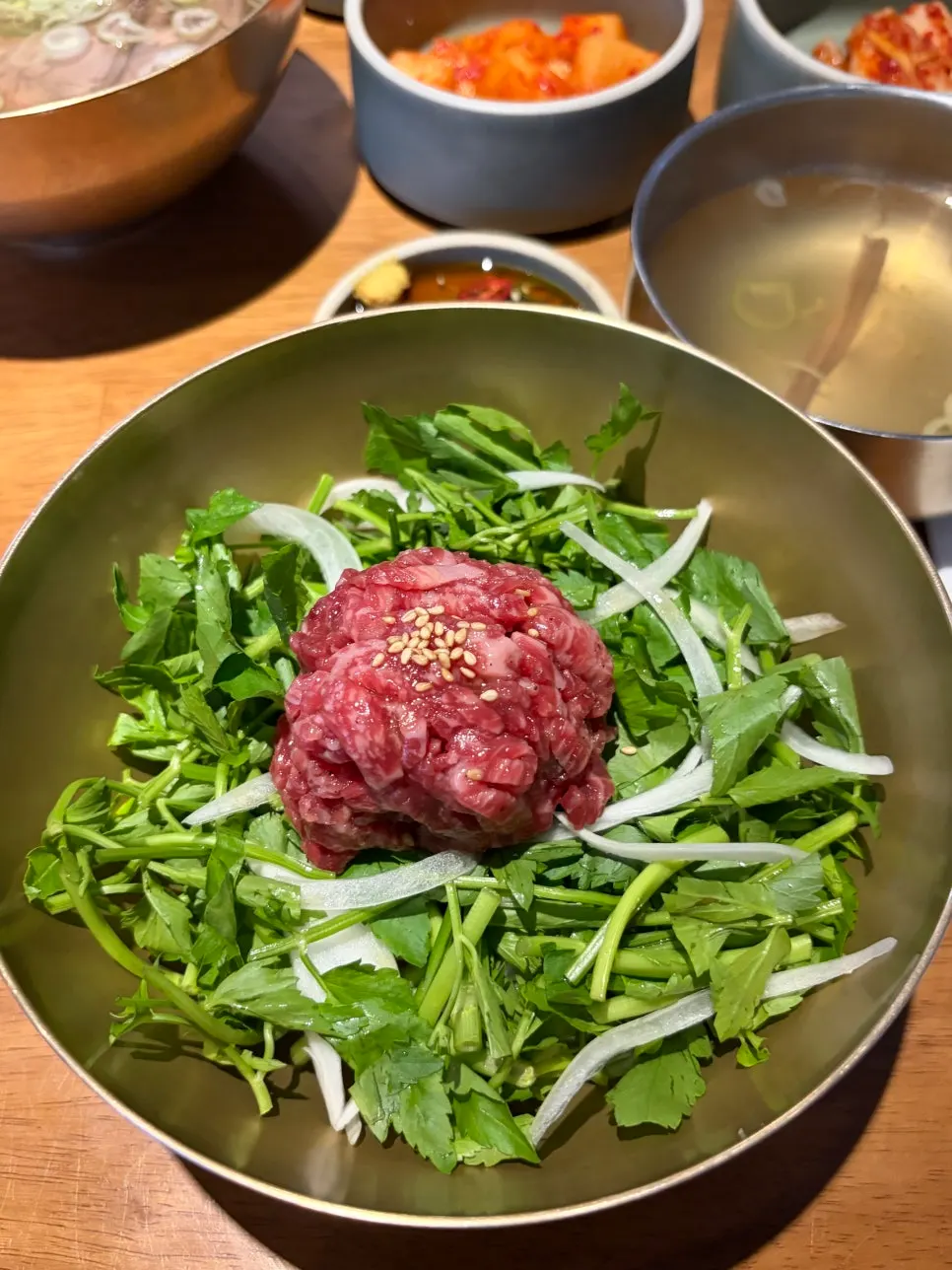 Yukhoe bibimbap generously topped with raw beef