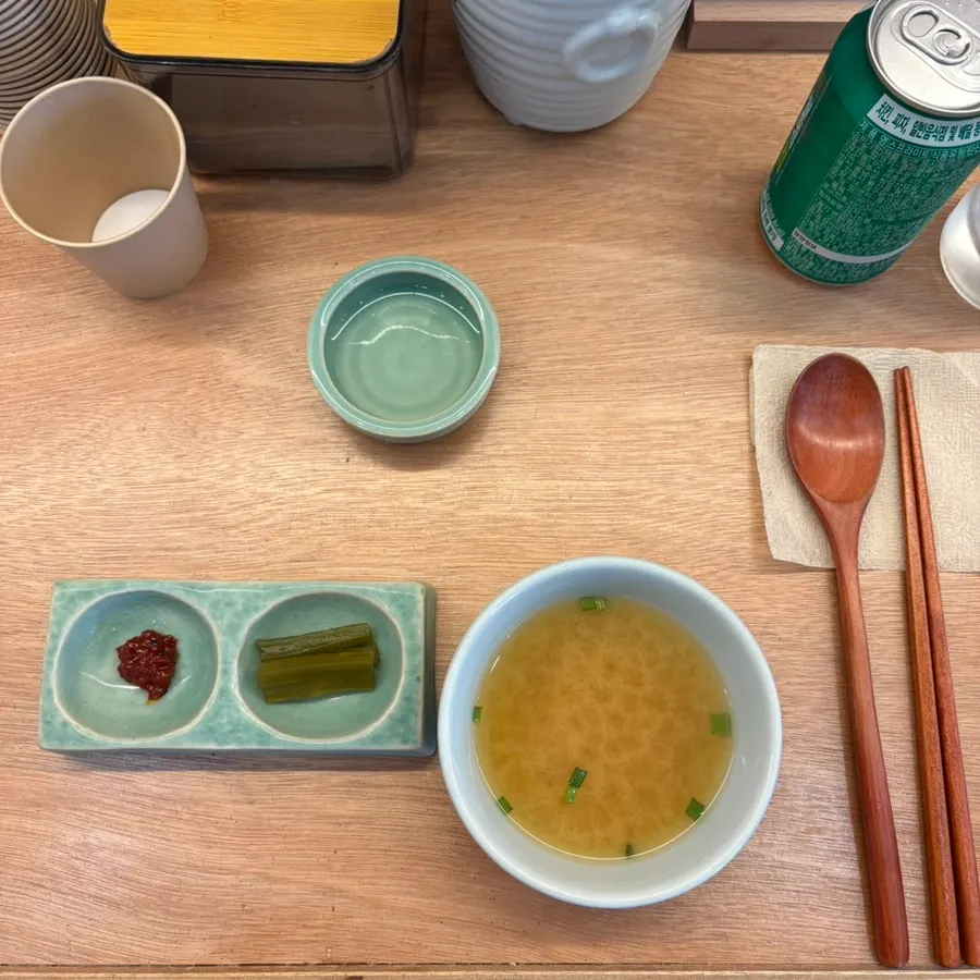 Table setting with paper cups, utensils, and tissues