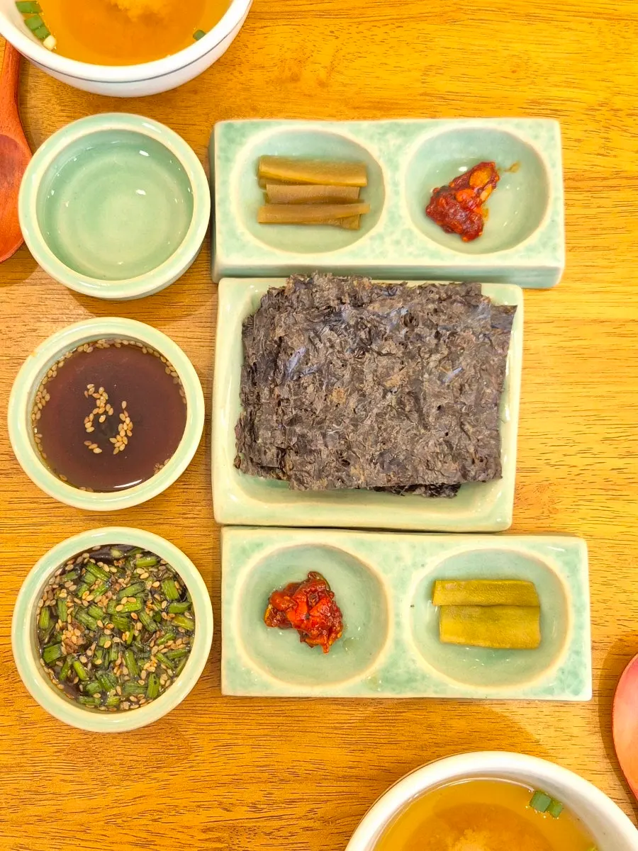 Side dishes served in ceramic bowls at Hyangtaek