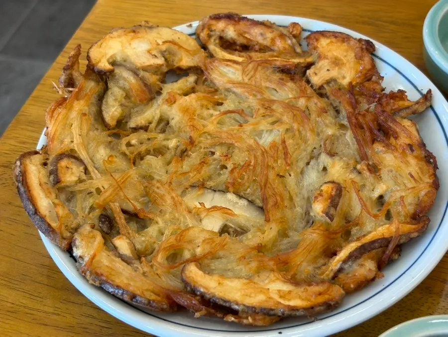 A golden-brown plate of grilled mushroom platter
