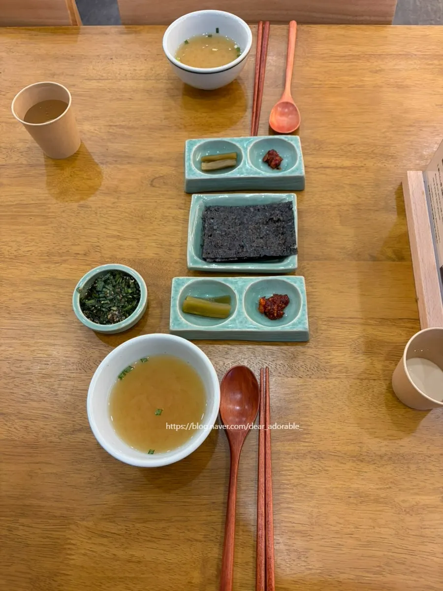 Basic table setting with doenjang soup, pickled gungchae, seasoned salted fish, and gim