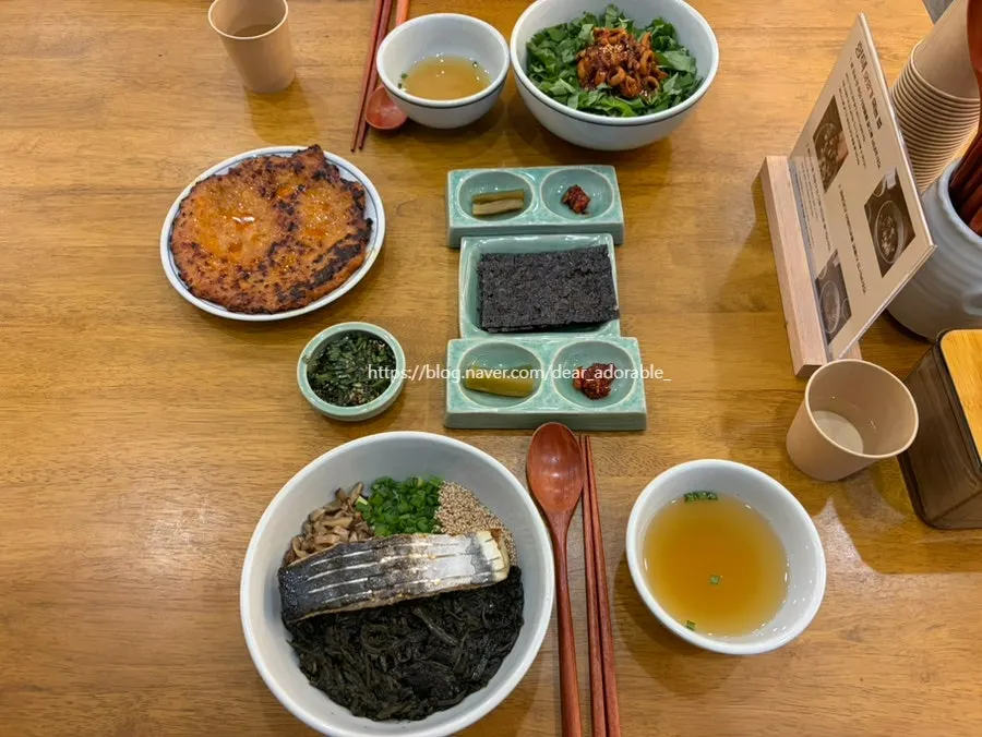 A spoonful of gondre rice topped with chicken bulgogi