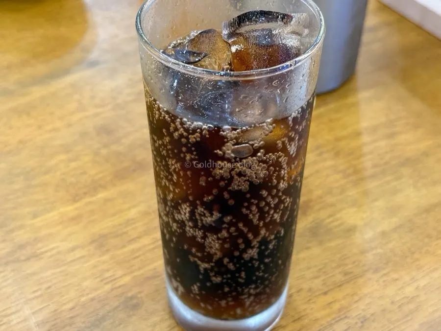 Canned cola served with a cup of ice