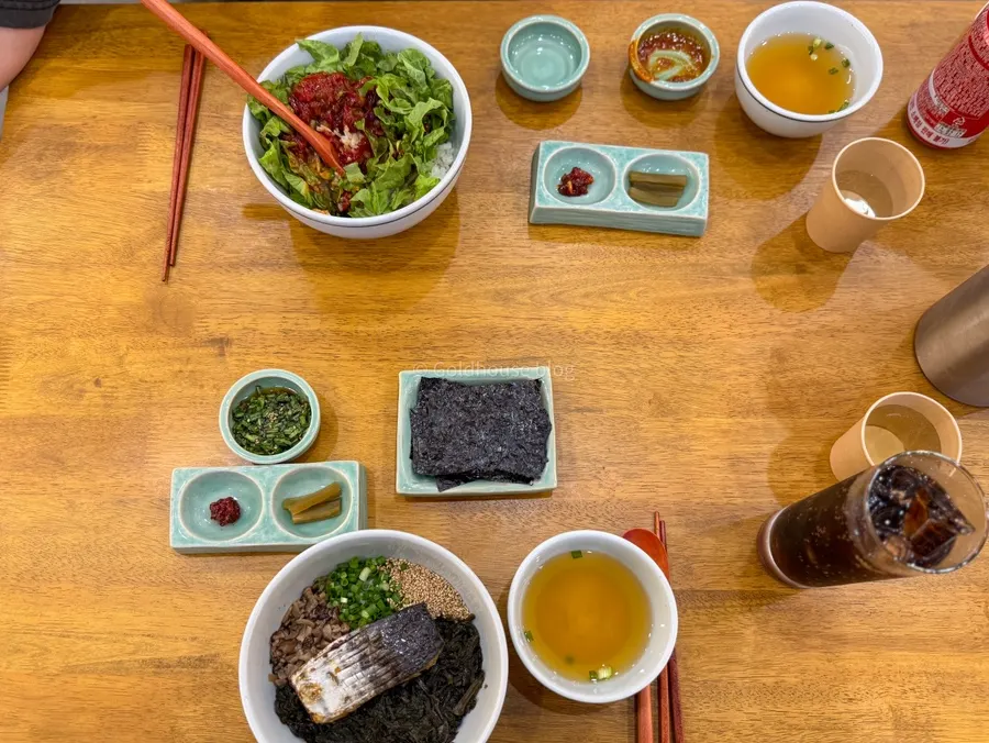 Full table setting with mackerel gondre rice and yukhoe bibimbap