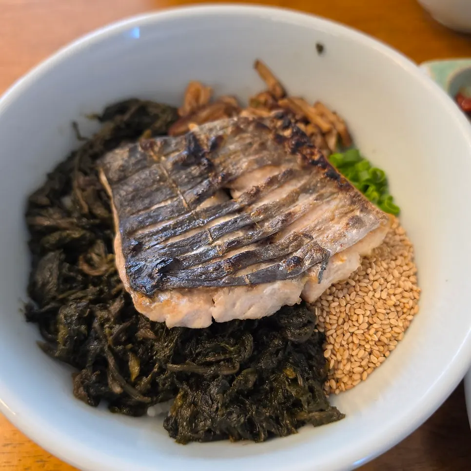 A spoonful of the spicy seasoned squid rice bowl