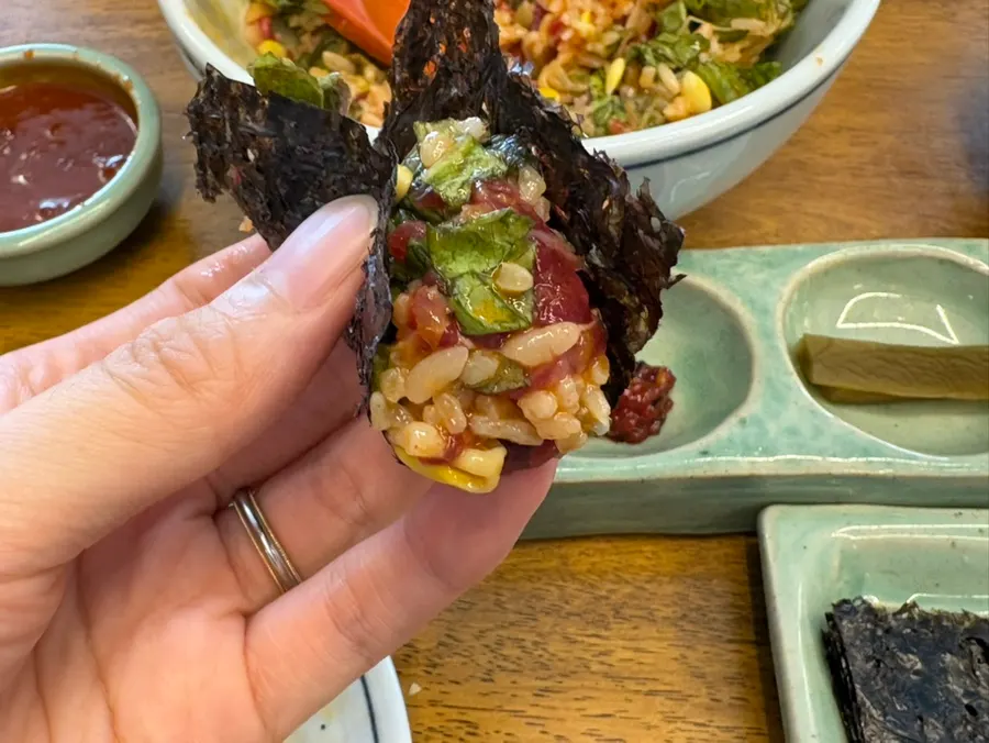 Yukhoe bibimbap with sauce and egg yolk added