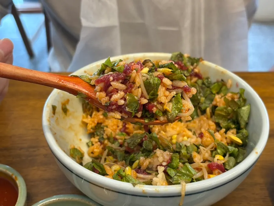 A spoonful of mixed yukhoe bibimbap