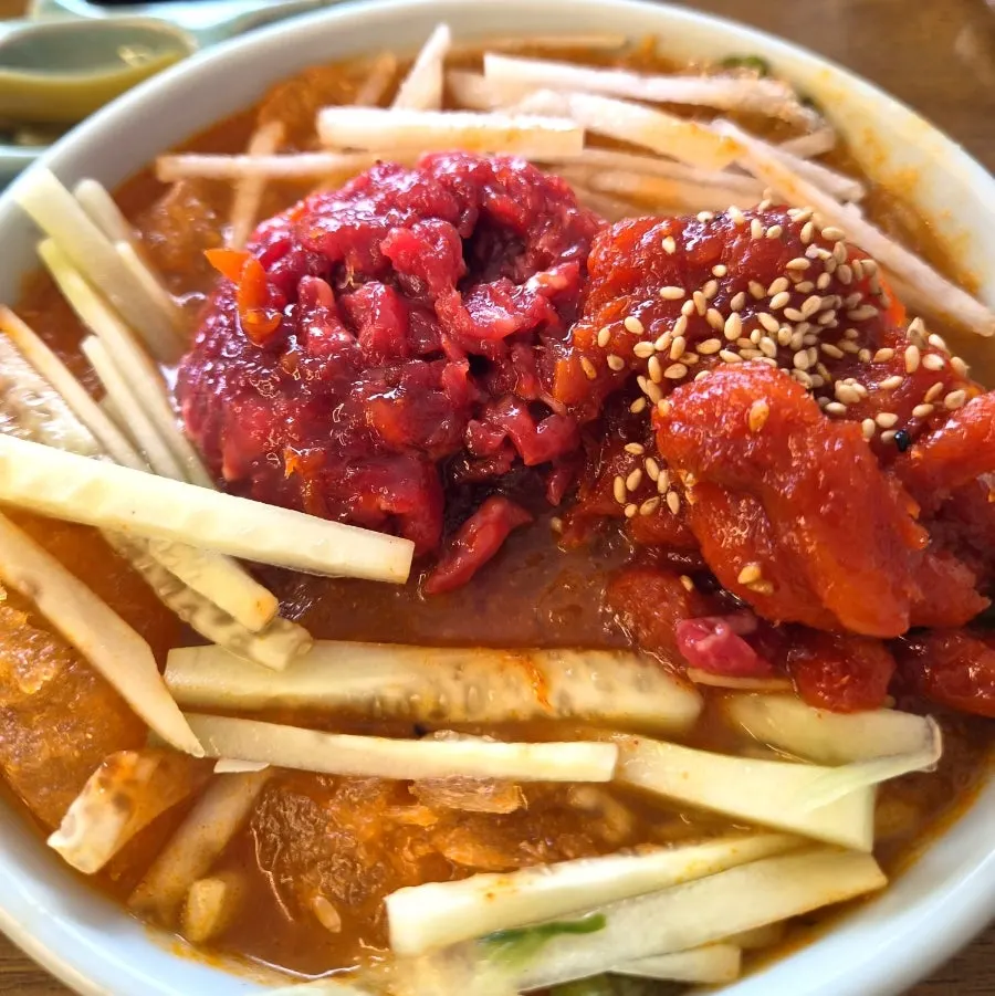 Bowl of pollock mulhoe yukhoe with crunchy vegetables