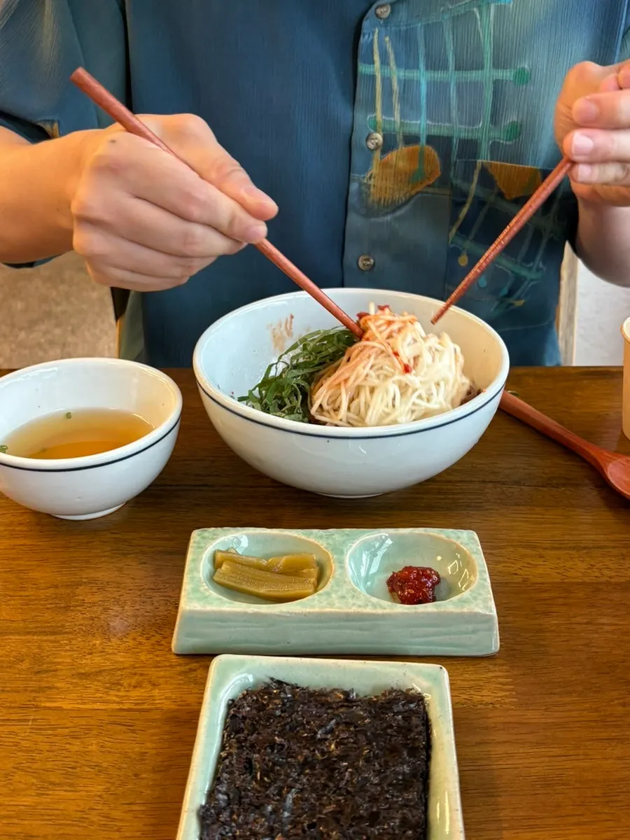 A spoonful of eggplant doenjang rice bowl lifted from the bowl