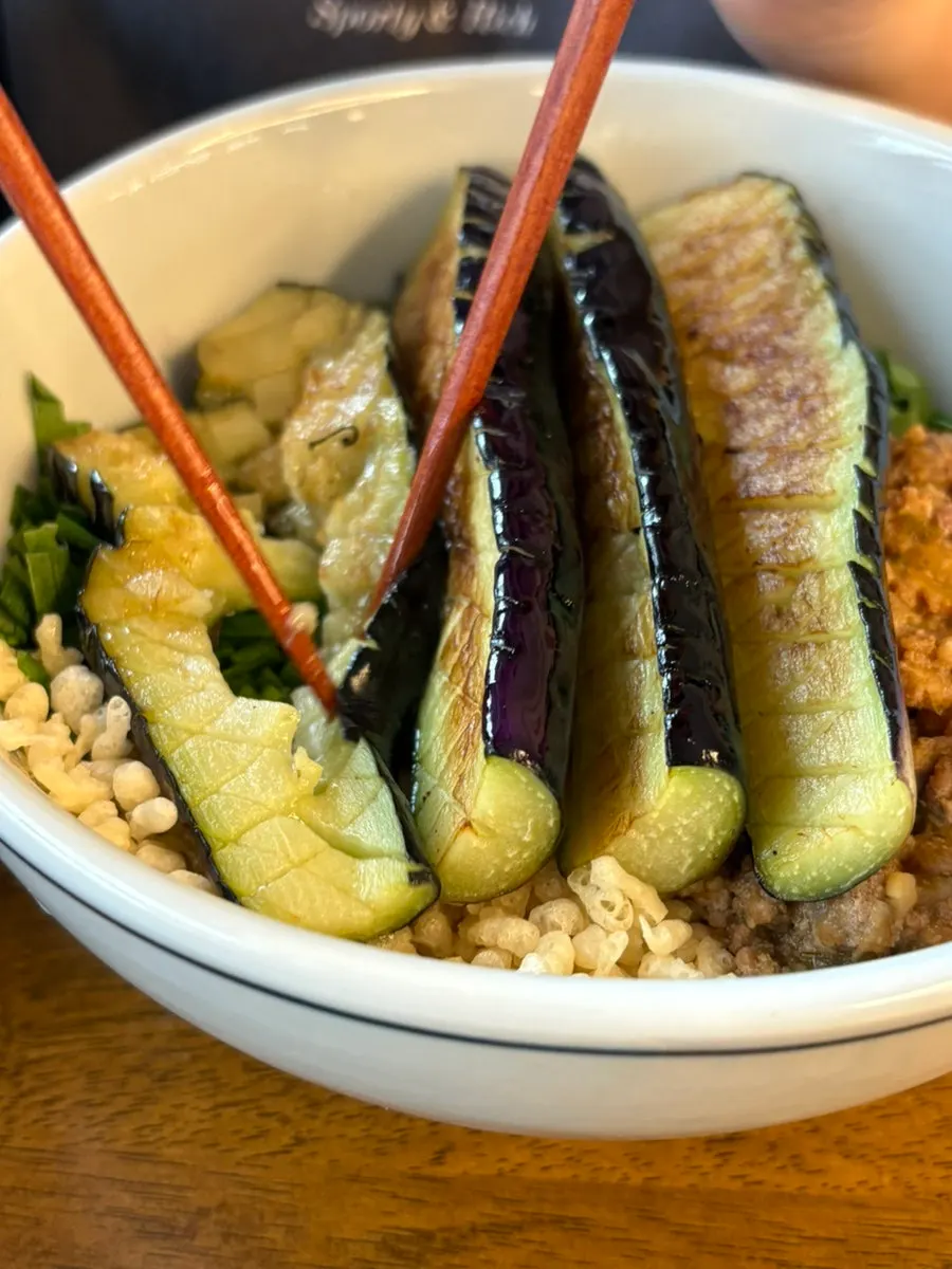 Hyangtaek Daebong's herring roe bibim noodles topped with perilla leaves and meat