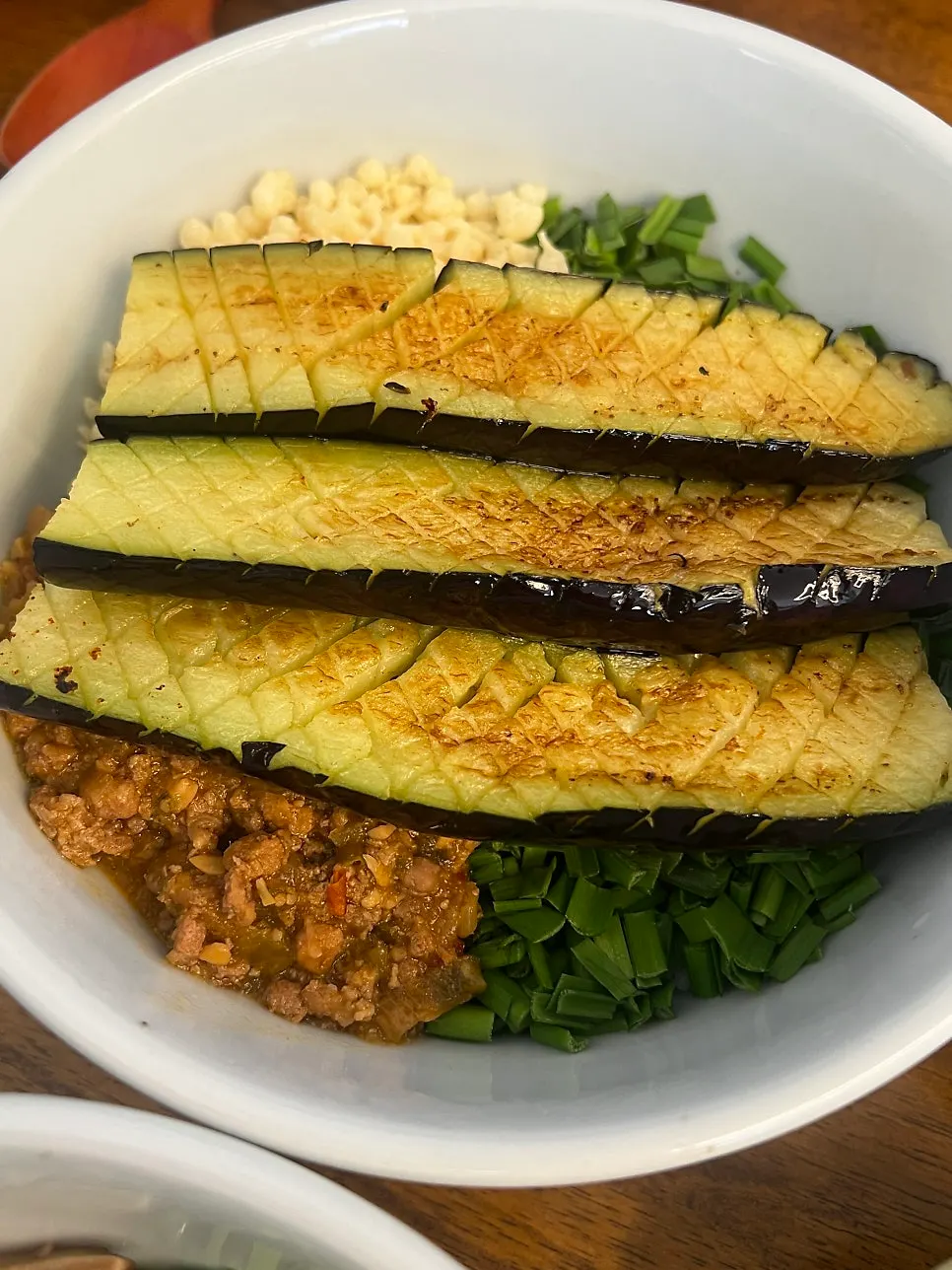 Eggplant doenjang rice bowl topped with generous chunks of grilled eggplant