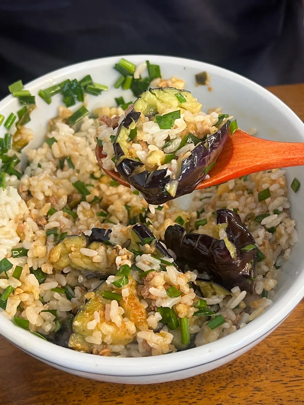 Spoonful of eggplant, minced meat, and chives together
