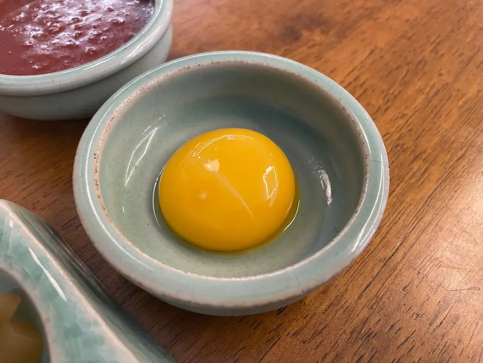 Egg yolk and gochujang served with the yukhoe bibimbap