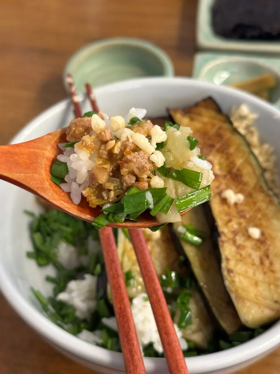 Eggplant doenjang rice bowl topped with chives and puffed rice