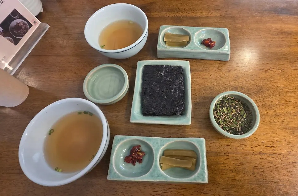Basic table setting with soup, gim, and side dishes