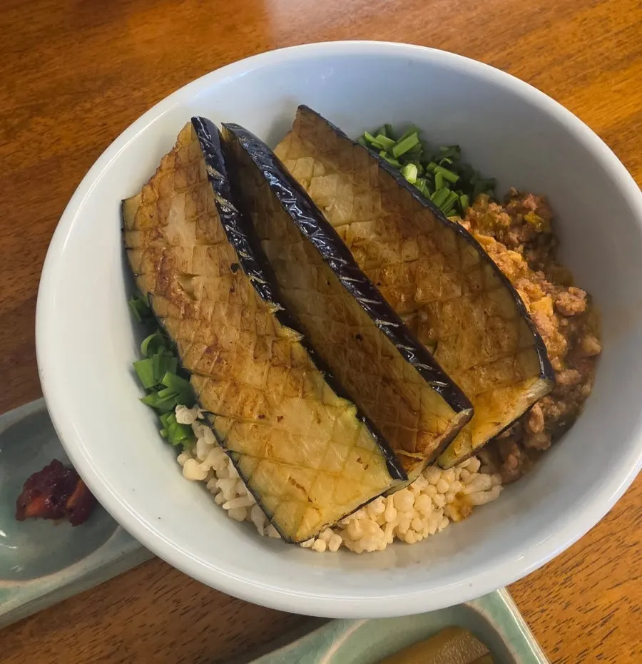 Eggplant doenjang rice bowl topped with ssamjang and fried crumble
