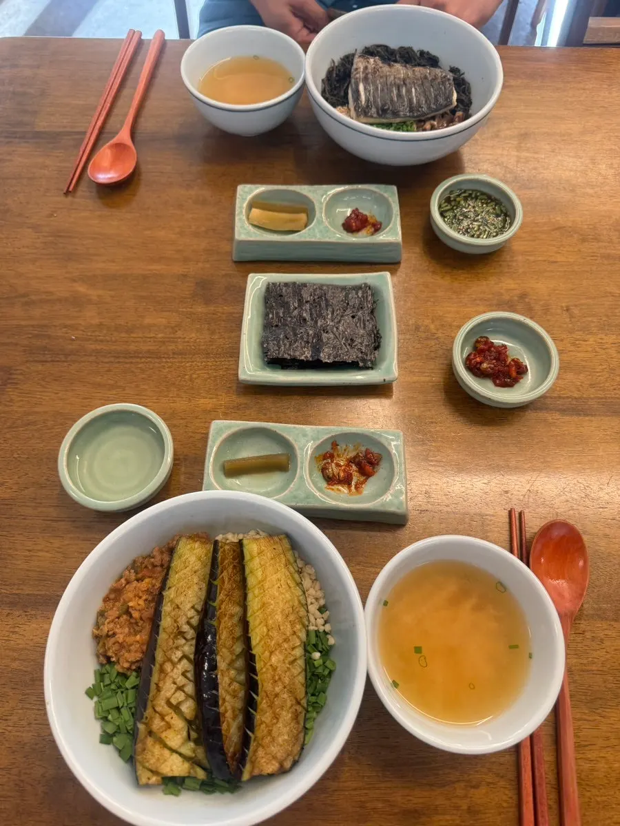 Plates of gungchae namul and jeotgal side dishes