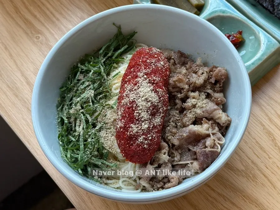 A spoonful of mackerel gondre rice with seasoning sauce