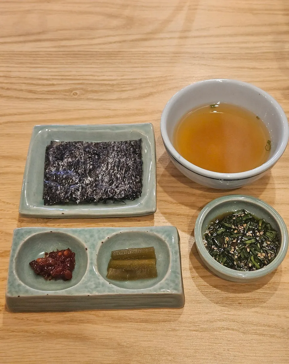 Miso soup, gopchang kim, bibim jeotgal, and gungchae jangajji side dishes