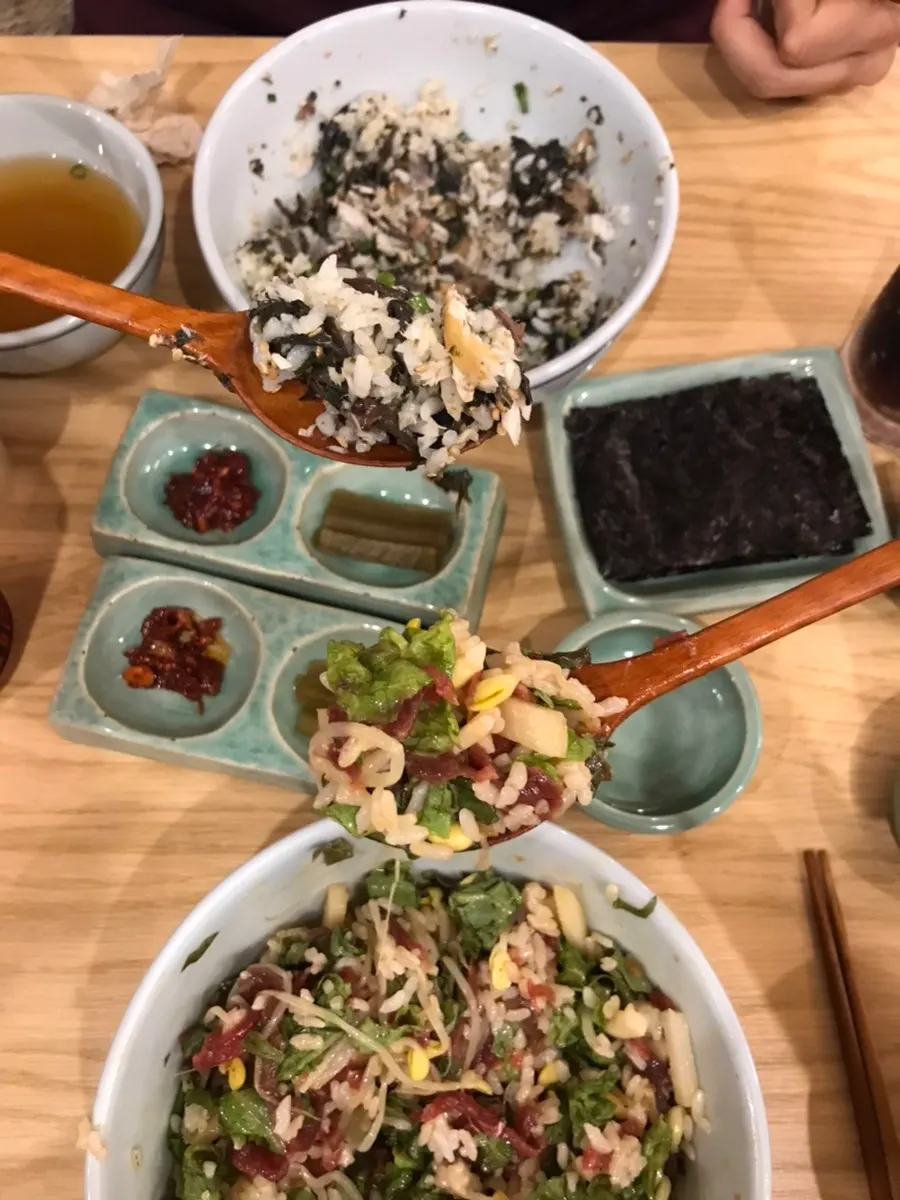 A spoonful of yukhoe bibimbap with bean sprouts