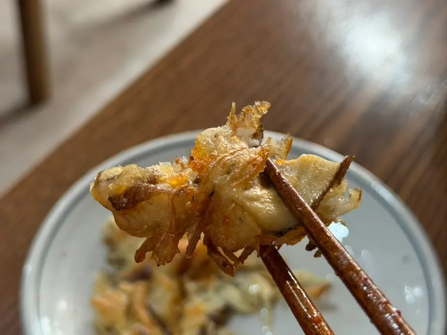 Picking up a piece of grilled mushroom